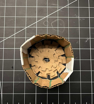 In the end we tried to stack them ontop of eachother again, with a tube surrounding the gears to hold them in place and because we had an idea to have the gears work in conjunction with the tube, the lines on the tube are meant to represent corners the gears would hit/cause friction on and move the tube, though we scrapped the idea because it was too complex.